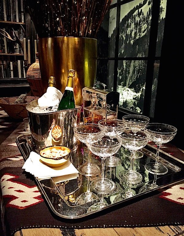 Clear wine glasses on tray near window