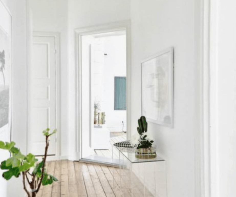 Blonde floors paired with crisp white walls creates a very Scandinavian look in a space that is swimming in sunshine for a relaxed summery vibe.