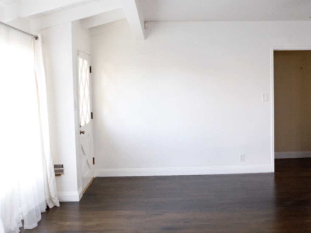 White walls anchored by a dark wood floor is a classic and dramatic combo just waiting for a beautiful rug and stunning art to make the space come alive.