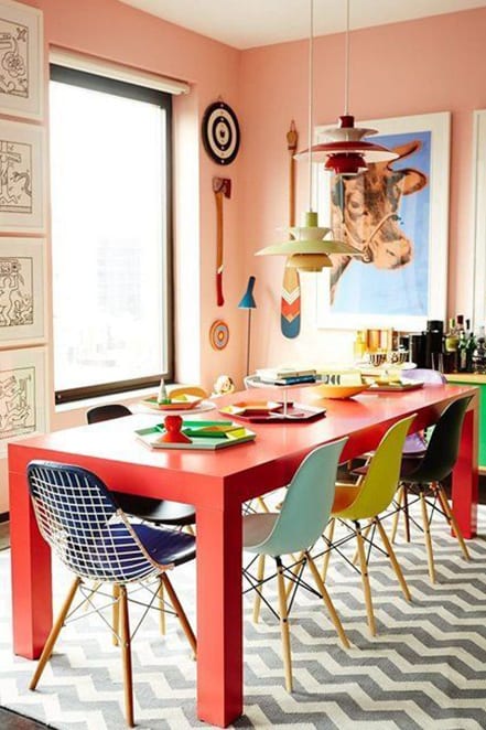 orange table and colored chairs