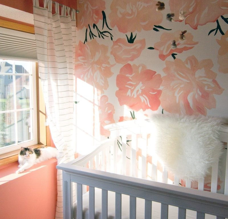 White wooden crib in front of window