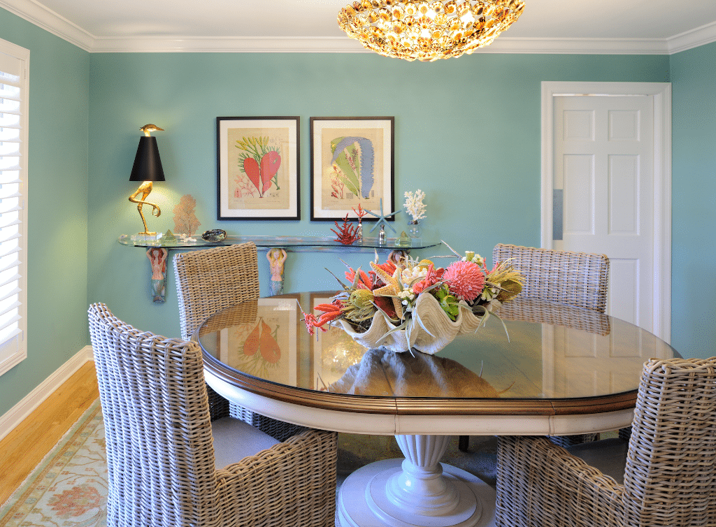 Oval brown wooden dining table with wicker chairs inside room