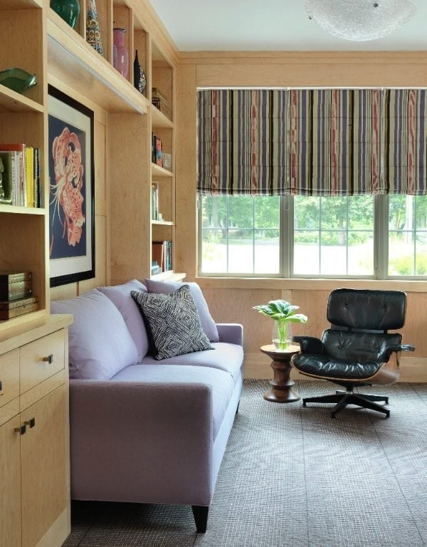 White fabric 2-seat sofa behind brown wooden cabinet