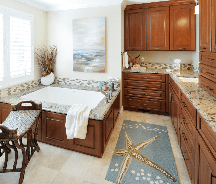Square brown wooden based bathtub with blue and yellow starfish rug