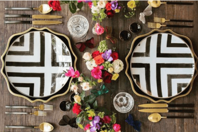 black and white plates with gold silverware