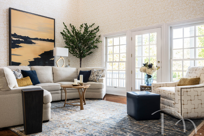 transitional neutral hearth room with blue patterned area rug by St. Louis interior designer