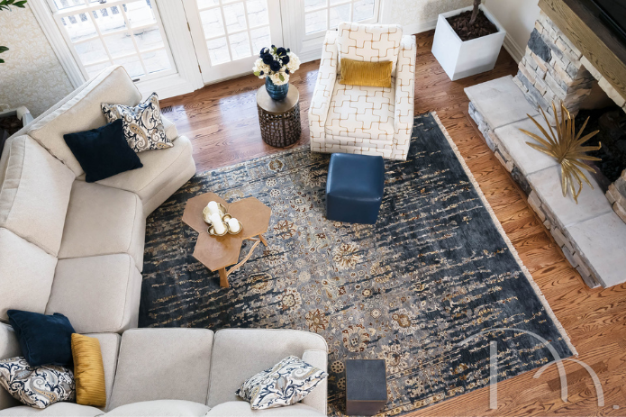 Overview of transitional hearth room with blue and brown rug